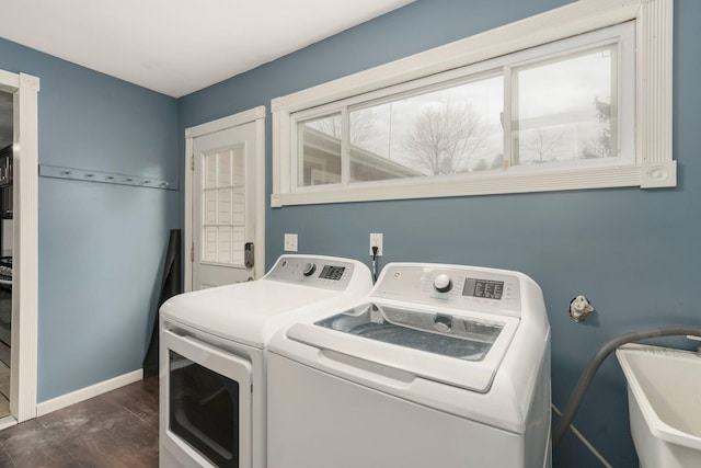 laundry room with a sink, dark wood-style floors, washing machine and dryer, baseboards, and laundry area