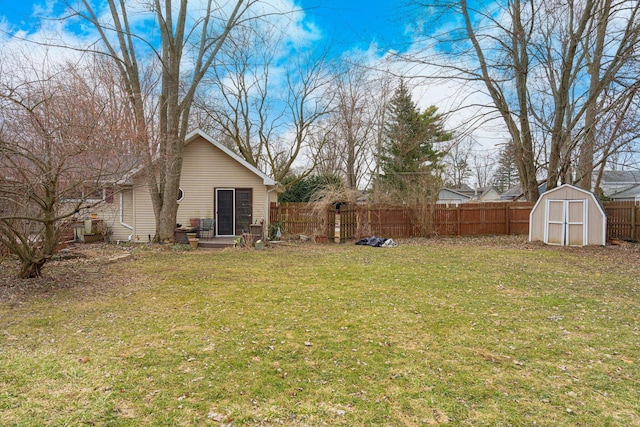 view of yard featuring an outbuilding, a storage unit, and fence