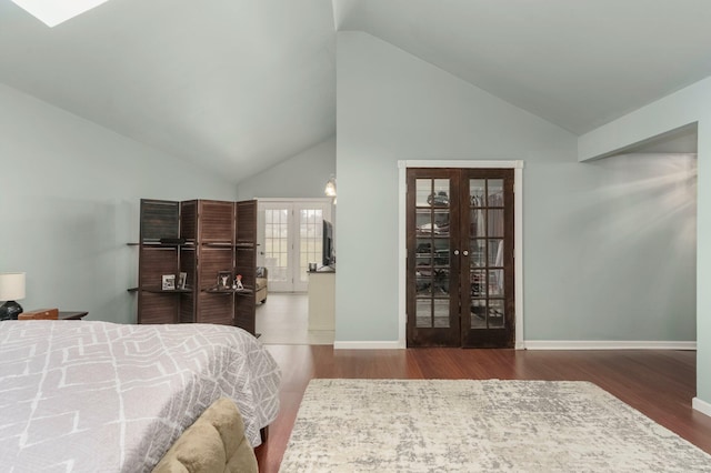 bedroom with wood finished floors, french doors, baseboards, and high vaulted ceiling