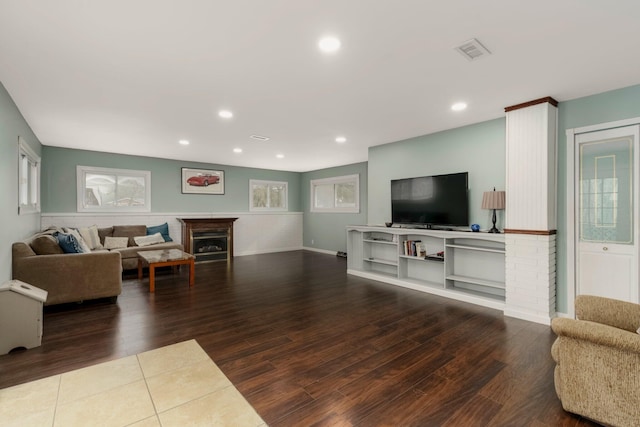 living room with recessed lighting, visible vents, wood finished floors, and a fireplace