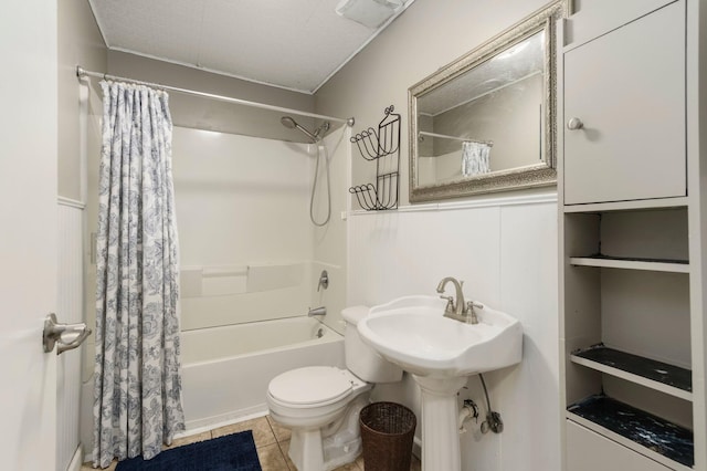 bathroom featuring tile patterned flooring, toilet, and shower / tub combo with curtain