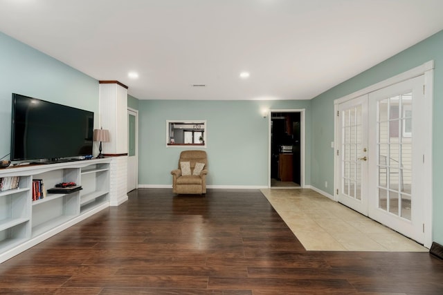 interior space with recessed lighting, french doors, baseboards, and wood finished floors