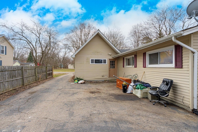 rear view of property featuring fence