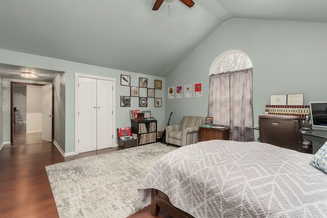 bedroom featuring wood finished floors, baseboards, ceiling fan, vaulted ceiling, and a closet