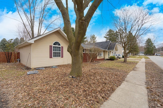 view of property exterior featuring fence