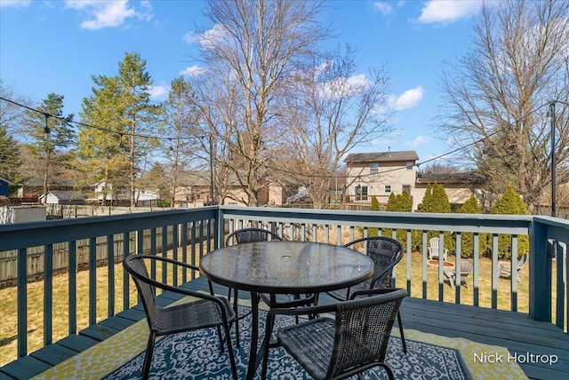 wooden terrace featuring outdoor dining area