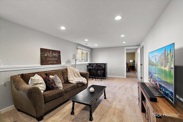 living area featuring light carpet, recessed lighting, and baseboards