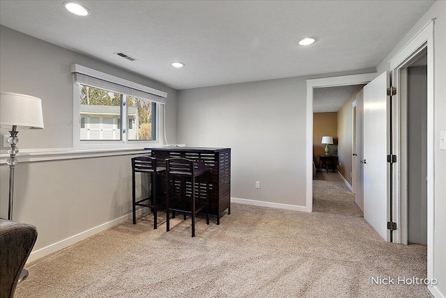 carpeted office space with recessed lighting, visible vents, and baseboards