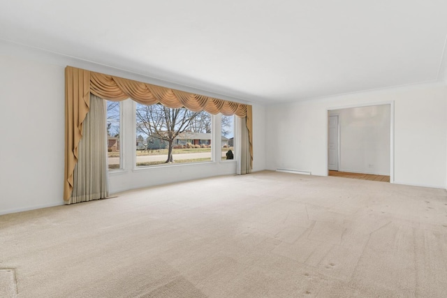 spare room featuring carpet flooring, baseboards, and baseboard heating