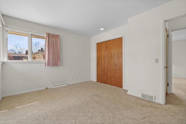 unfurnished bedroom featuring a closet, baseboards, visible vents, and carpet floors