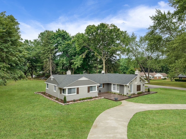 ranch-style home with a front yard, a shingled roof, a chimney, concrete driveway, and brick siding