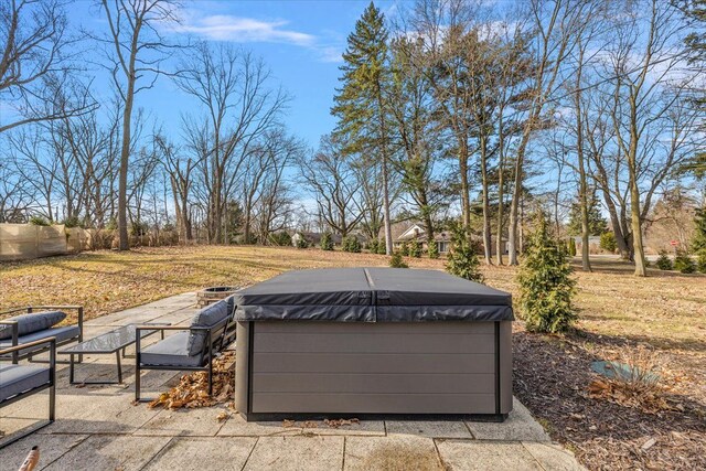 view of patio featuring a hot tub and fence