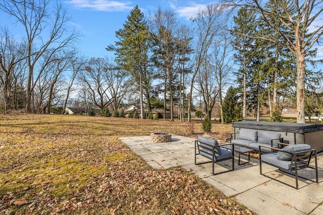 view of yard featuring an outdoor living space with a fire pit and a patio