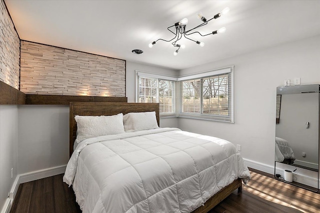 bedroom featuring baseboards and wood finished floors