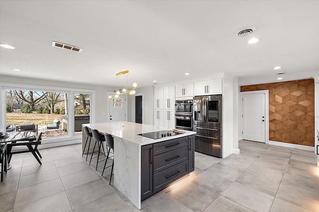 kitchen featuring visible vents, recessed lighting, white cabinetry, and black appliances