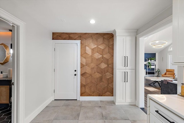 corridor with light tile patterned floors, recessed lighting, and baseboards