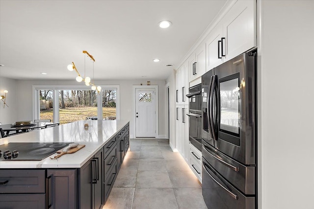 kitchen featuring wall oven, light stone counters, refrigerator with ice dispenser, white cabinets, and black electric cooktop