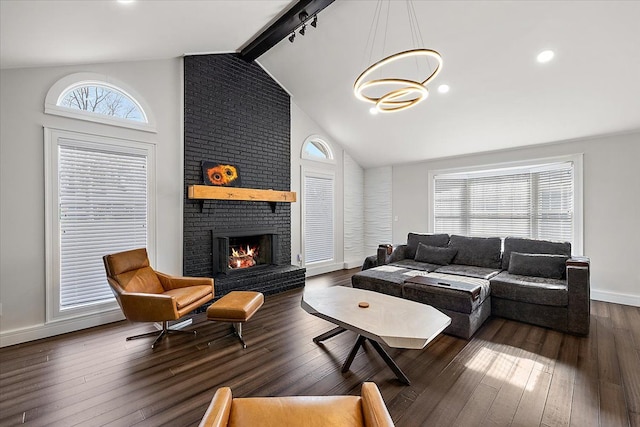 living room with beamed ceiling, baseboards, hardwood / wood-style floors, and a fireplace