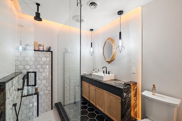 full bath with vanity, visible vents, tile patterned flooring, a shower stall, and toilet