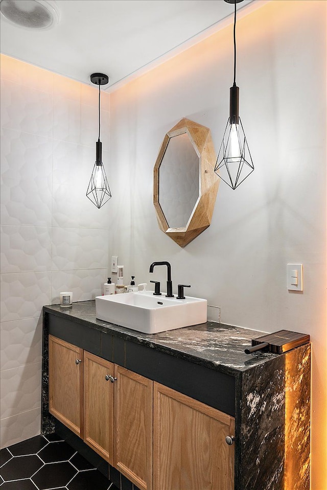 bathroom with tile patterned flooring, vanity, and tile walls