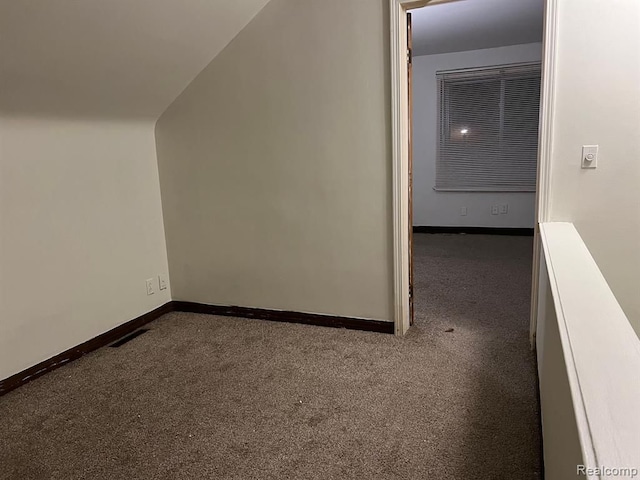 additional living space with visible vents, baseboards, and carpet