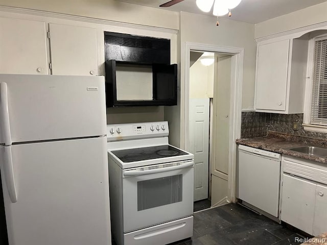 kitchen with tasteful backsplash, dark countertops, white appliances, white cabinetry, and a sink