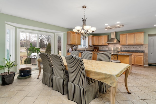 dining space with light tile patterned flooring, plenty of natural light, recessed lighting, and a notable chandelier