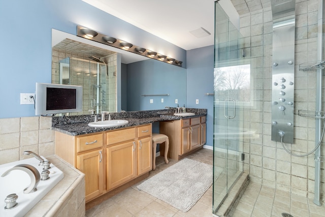 bathroom with vanity, a bath, a shower stall, and tile patterned flooring