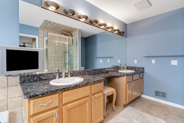 bathroom with a sink, visible vents, a stall shower, and double vanity