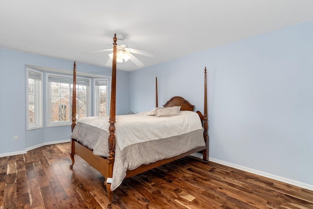 bedroom with a ceiling fan, baseboards, and wood-type flooring