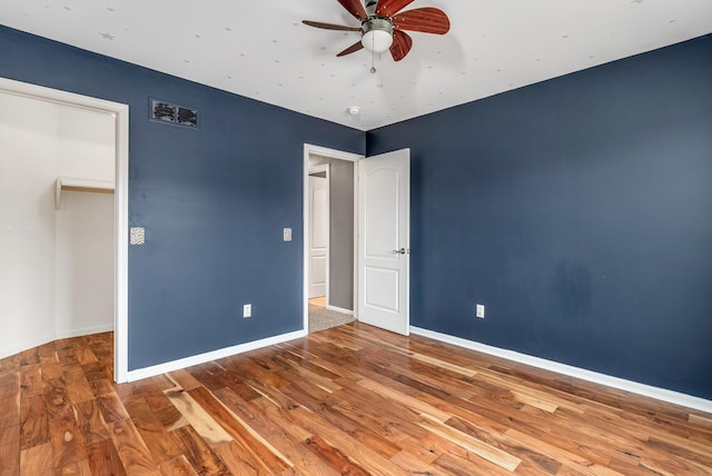 unfurnished bedroom featuring wood finished floors and baseboards