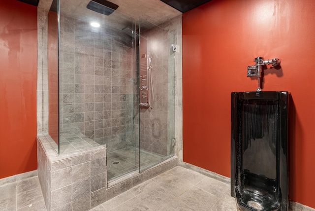 bathroom featuring baseboards and a stall shower