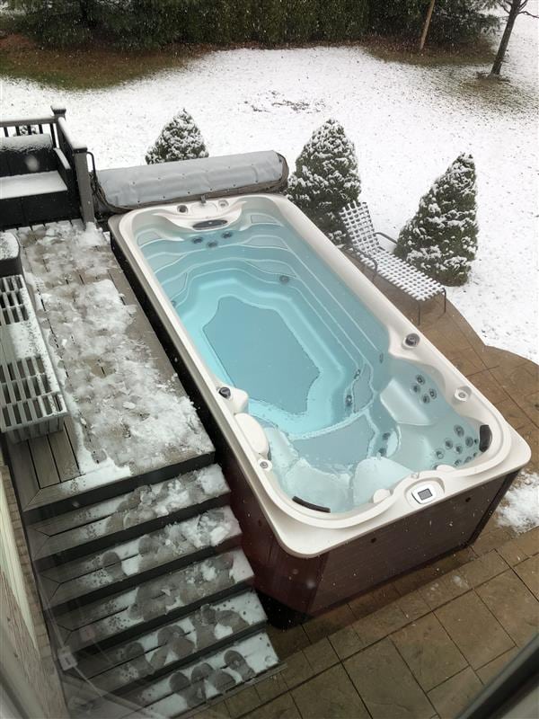 view of swimming pool featuring hot tub deck surround