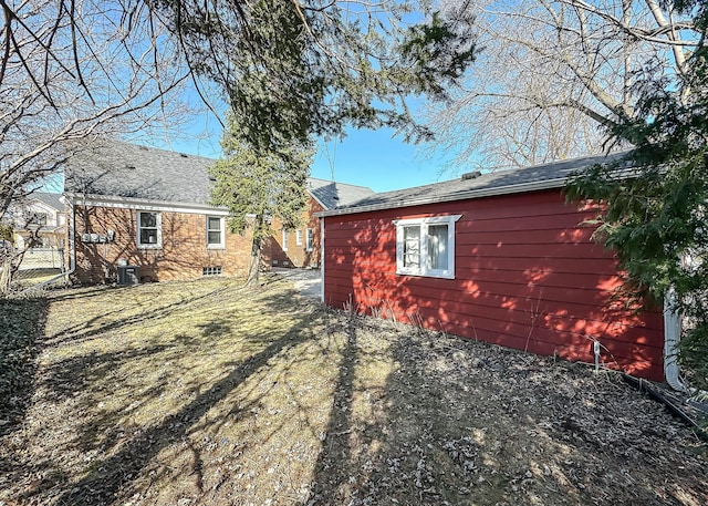 exterior space featuring central AC unit and fence