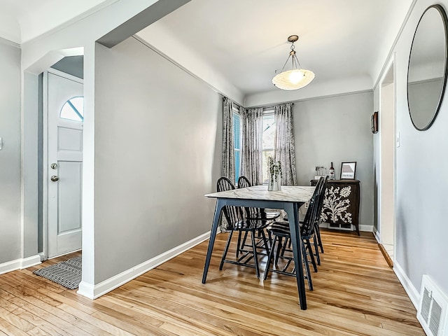 dining area featuring visible vents, baseboards, and light wood-style floors