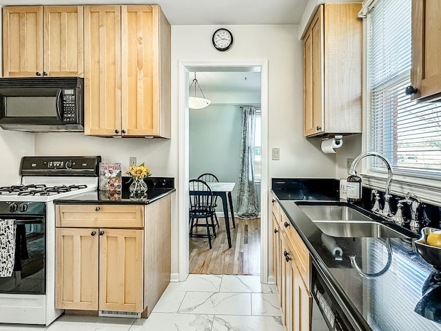 kitchen featuring light brown cabinetry, a sink, black microwave, range with gas cooktop, and marble finish floor