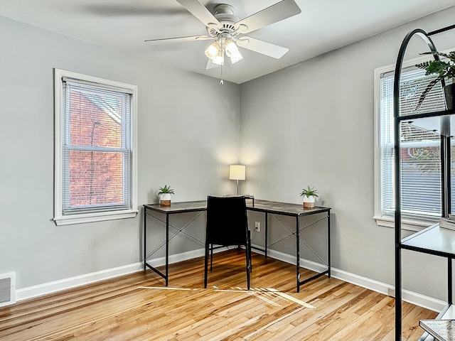 home office with ceiling fan, baseboards, and wood finished floors