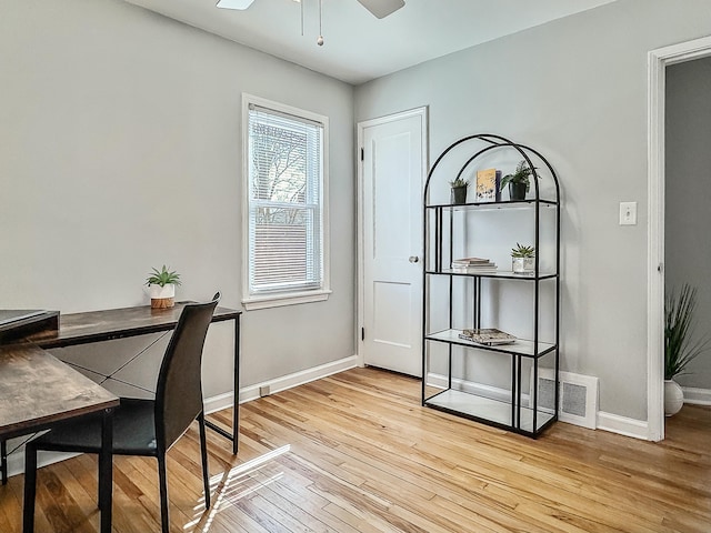 office space featuring ceiling fan, baseboards, visible vents, and light wood-type flooring