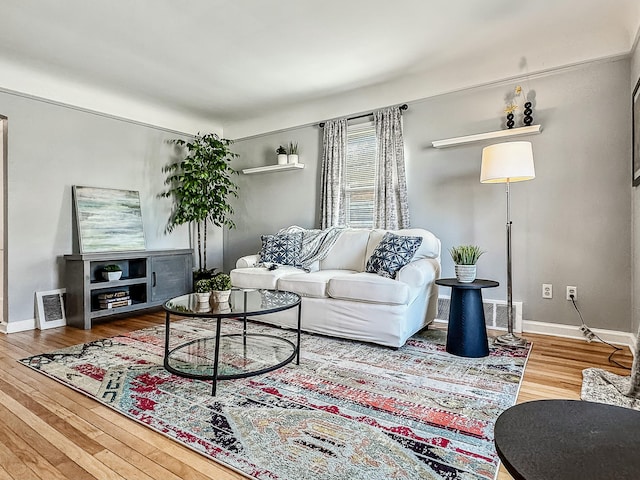 living room with wood finished floors and baseboards