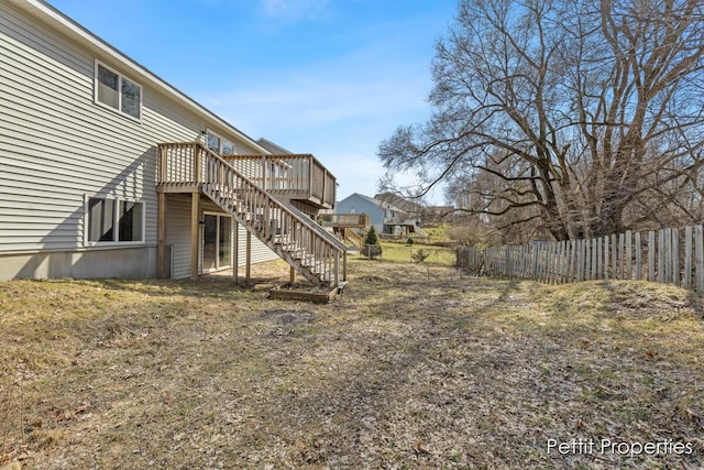 view of yard featuring stairway, a wooden deck, and fence