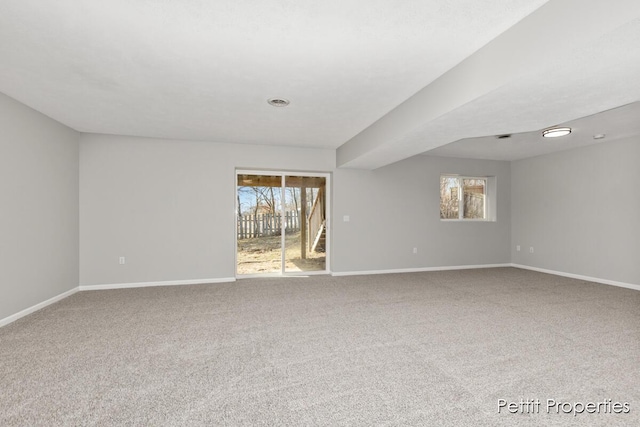 unfurnished room with baseboards and carpet floors