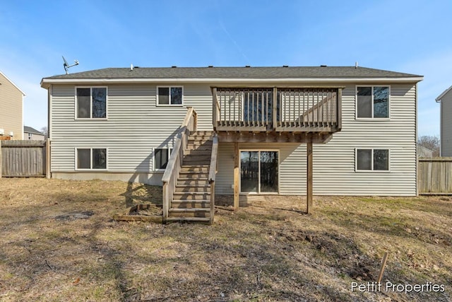 back of property featuring a wooden deck, stairs, and fence