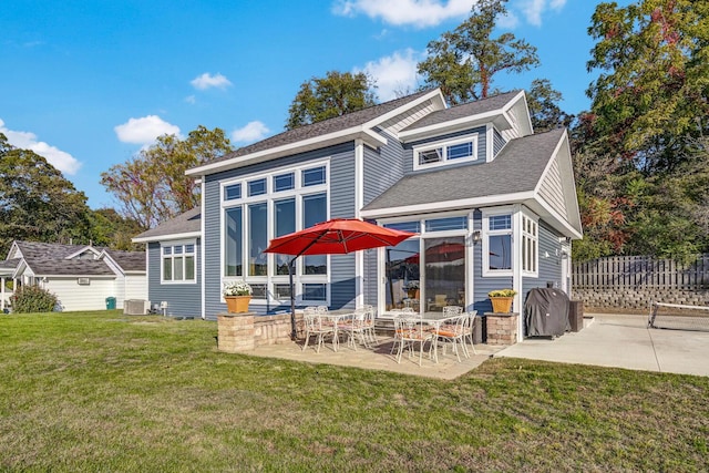 back of property with a yard, fence, central AC, and a patio area