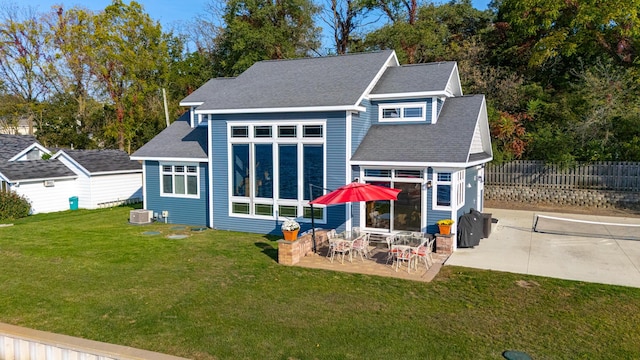 back of house featuring a patio, a lawn, central AC, and fence