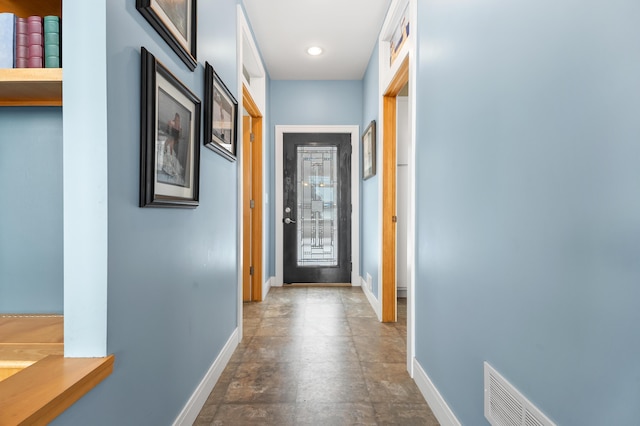 hallway featuring visible vents and baseboards