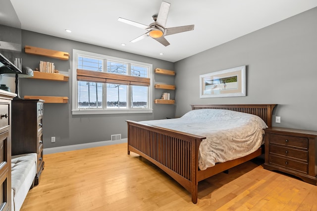 bedroom featuring a ceiling fan, visible vents, baseboards, recessed lighting, and light wood-style floors