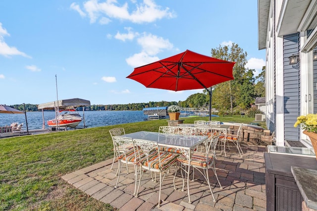 view of patio / terrace with outdoor dining area and a water view