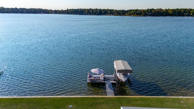 dock area featuring boat lift and a water view