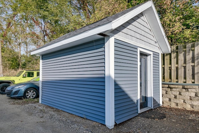 view of shed featuring fence