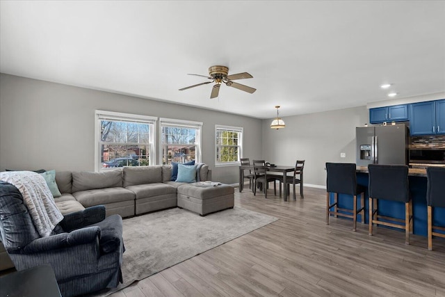 living room featuring light wood finished floors, recessed lighting, baseboards, and a ceiling fan